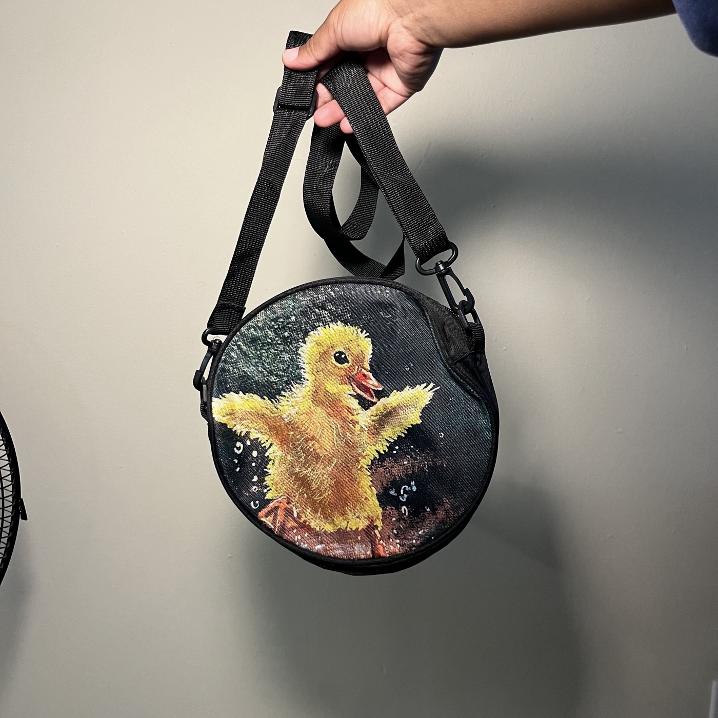 Ducky Playing In Puddle — Round crossbody bag, photographed by the artist