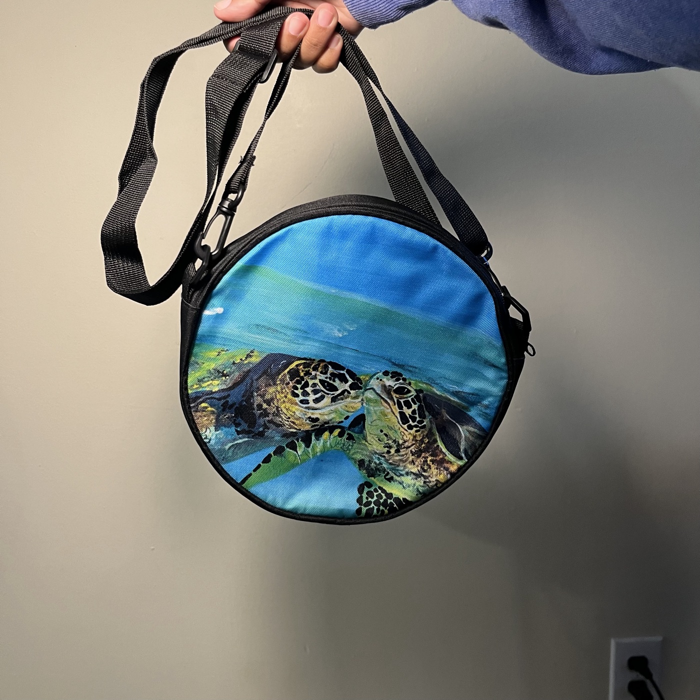 Kissing Honu (Turtles) — Round crossbody bag, photographed by the artist