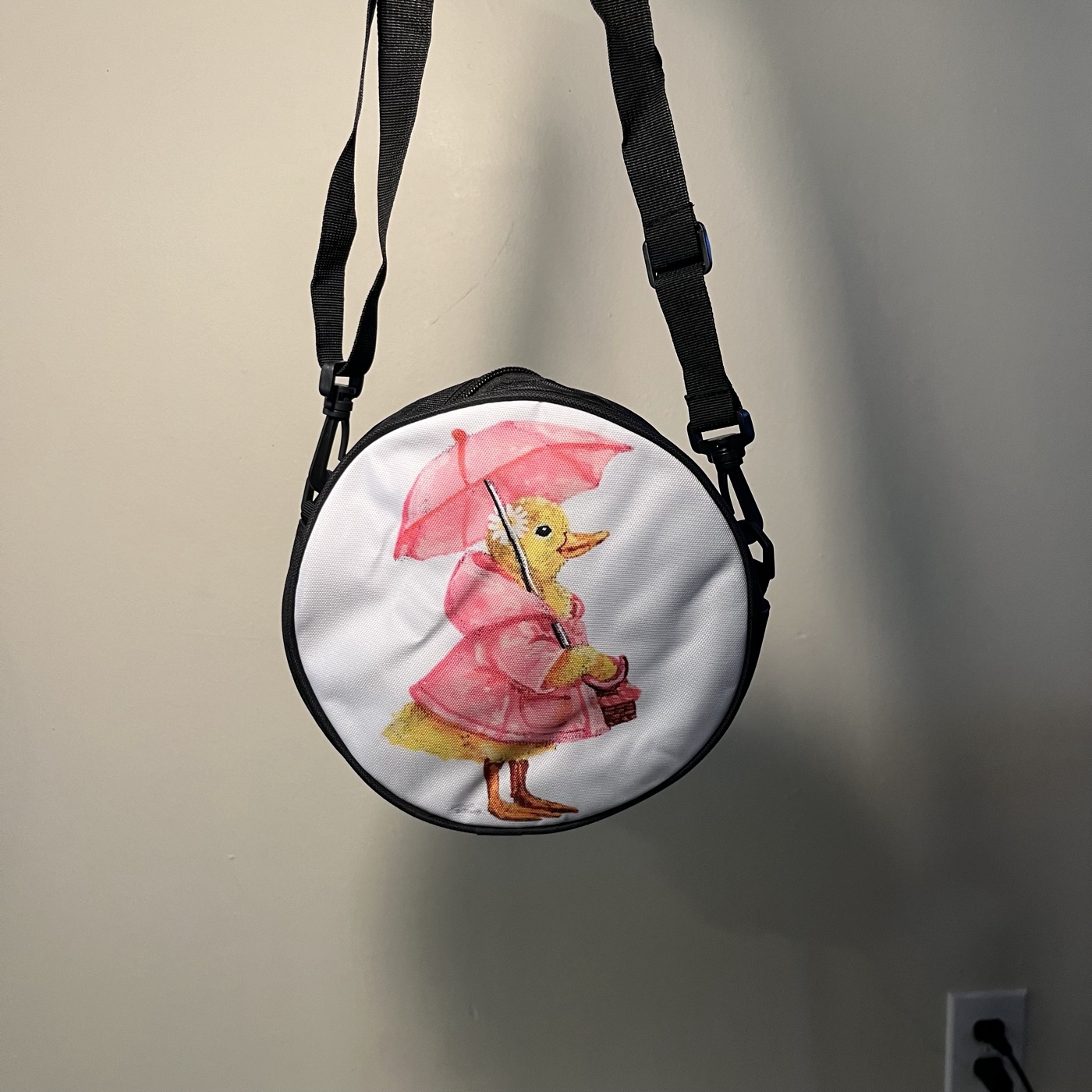 Ms. Ducky — Round crossbody bag, photographed by the artist