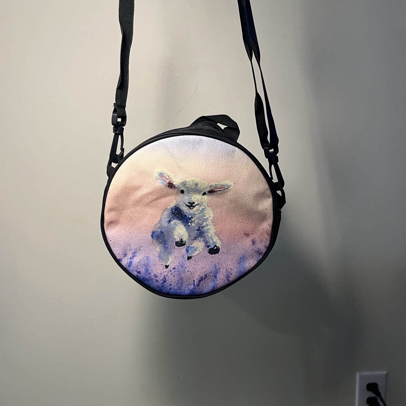 The Leaping Lamb — Round crossbody bag, photographed by the artist